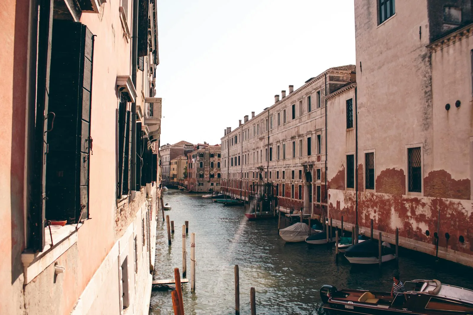 A canal in venice with boats and buildings