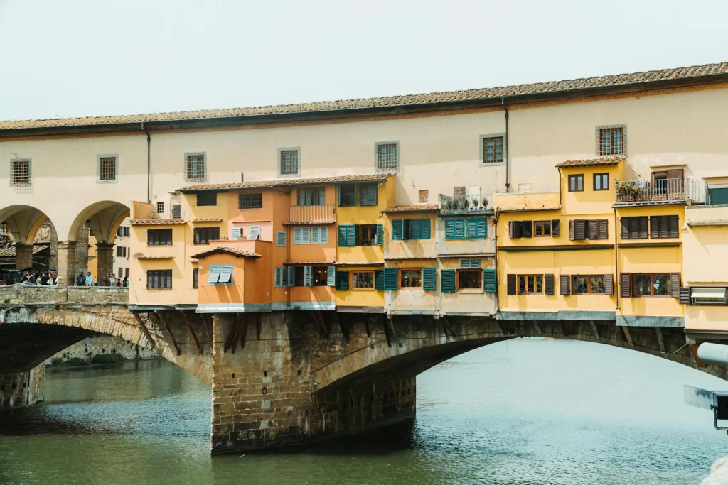 A bridge over a river with colorful buildings