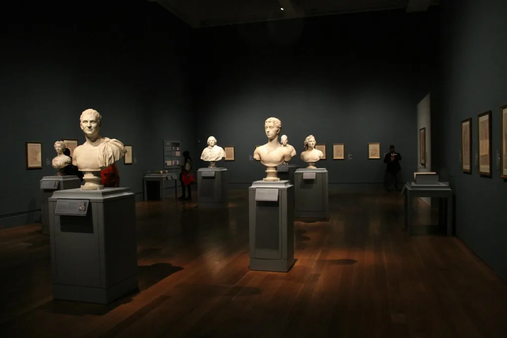 Assorted Busts on Gray Stand