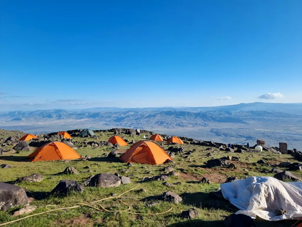 a group of tents set up on top of a mountain